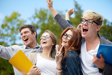 Image showing group of happy students showing triumph gesture