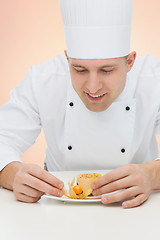 Image showing happy male chef cook decorating dessert