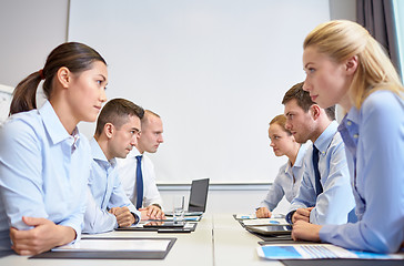 Image showing smiling business people having conflict in office