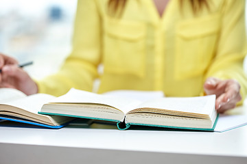 Image showing close up of female hands to book or textbook