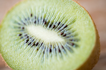 Image showing close up of ripe kiwi slice on table