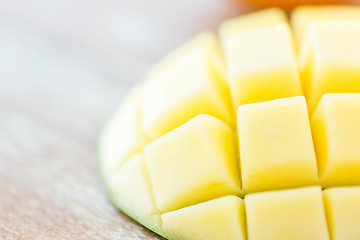 Image showing close up of ripe mango slice on table