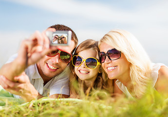 Image showing happy family with camera taking picture