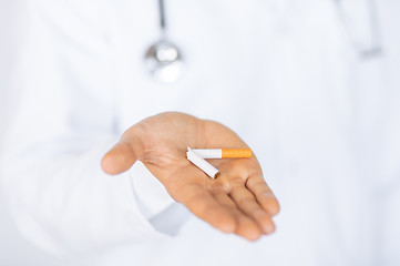 Image showing man breaking the cigarette with hands