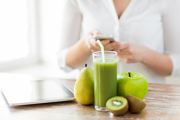 Image showing close up of woman with smartphone and fruits