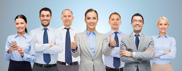 Image showing group of happy businesspeople showing thumbs up