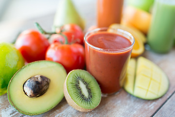 Image showing close up of fresh juice glass and fruits on table