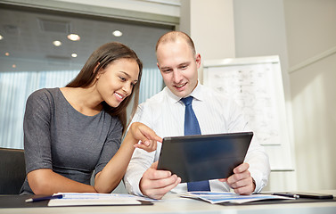 Image showing smiling businesspeople with tablet pc in office