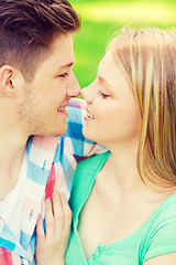 Image showing smiling couple touching noses in park