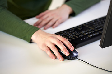 Image showing close up of male hands holding computer mouse