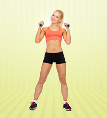 Image showing young sporty woman with dumbbells