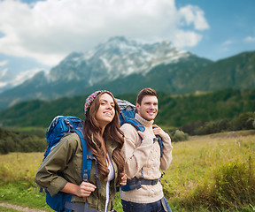 Image showing smiling couple with backpacks hiking