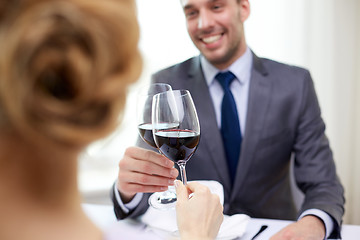 Image showing happy couple with glasses of wine at restaurant