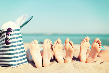 Image showing three women lying on the beach