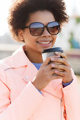 Image showing smiling african american woman drinking coffee