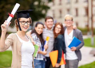 Image showing happy teenage students with diploma and folders