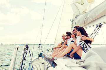 Image showing smiling friends sitting on yacht deck