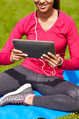 Image showing close up of smiling woman with tablet pc outdoors