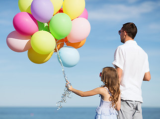 Image showing father and daughter with colorful balloons