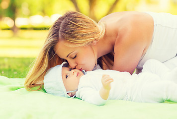 Image showing happy mother lying with little baby on blanket