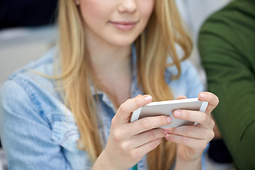 Image showing close up of female hands with smartphone