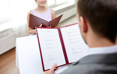 Image showing close up of couple with menu at restaurant