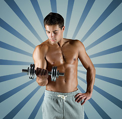 Image showing young man with dumbbell flexing biceps