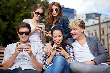 Image showing students or teenagers with smartphones at campus