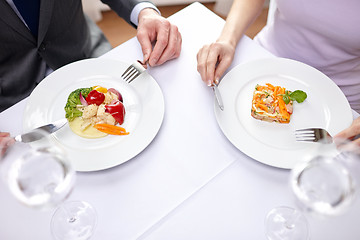 Image showing close up of couple eating appetizers at restaurant