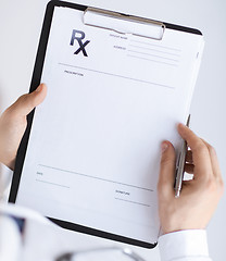 Image showing male doctor writing prescription paper