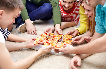 Image showing close up of happy friends eating pizza at home