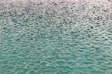 Image showing water surface with raindrops at rainy day