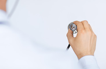 Image showing doctor hand with stethoscope listening somebody