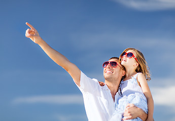 Image showing happy father and child in sunglasses over blue sky