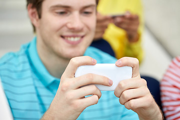Image showing close up of young man with smartphone