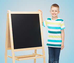 Image showing happy little boy with blank blackboard