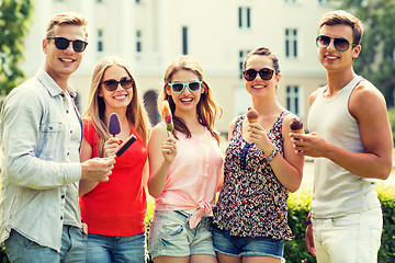 Image showing group of smiling friends with ice cream outdoors