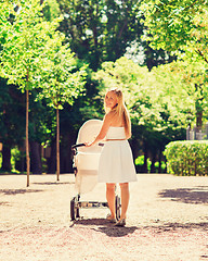 Image showing happy mother with stroller in park