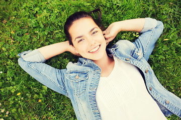 Image showing smiling young girl lying on grass