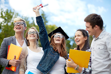 Image showing group of smiling students with diploma and folders