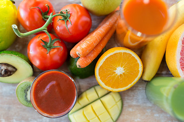 Image showing close up of fresh juice glass and fruits on table