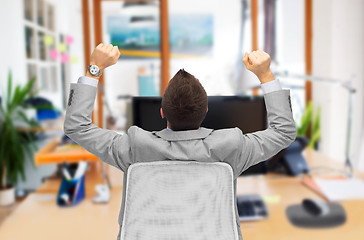 Image showing businessman sitting in office chair from back