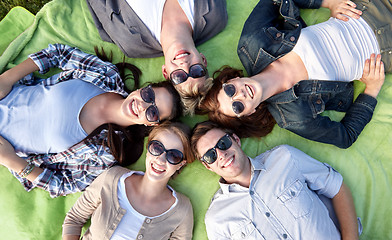 Image showing group of students or teenagers lying in circle