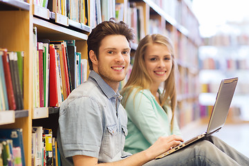 Image showing happy students with laptop in library