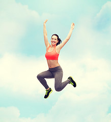 Image showing sporty teenage girl jumping in sportswear