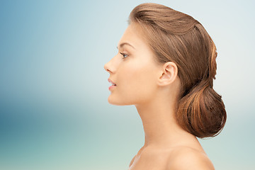 Image showing beautiful young woman face over blue background