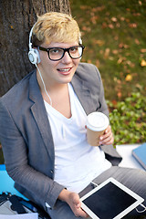 Image showing happy teenage boy in headphones with tablet pc