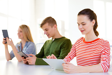 Image showing smiling students with tablet pc at school