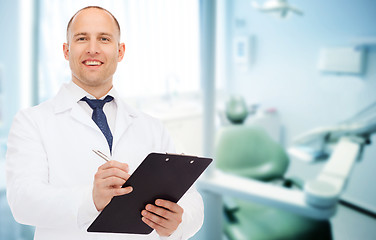 Image showing smiling male doctor with clipboard