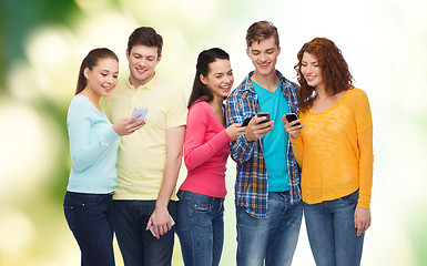 Image showing group of smiling teenagers with smartphones